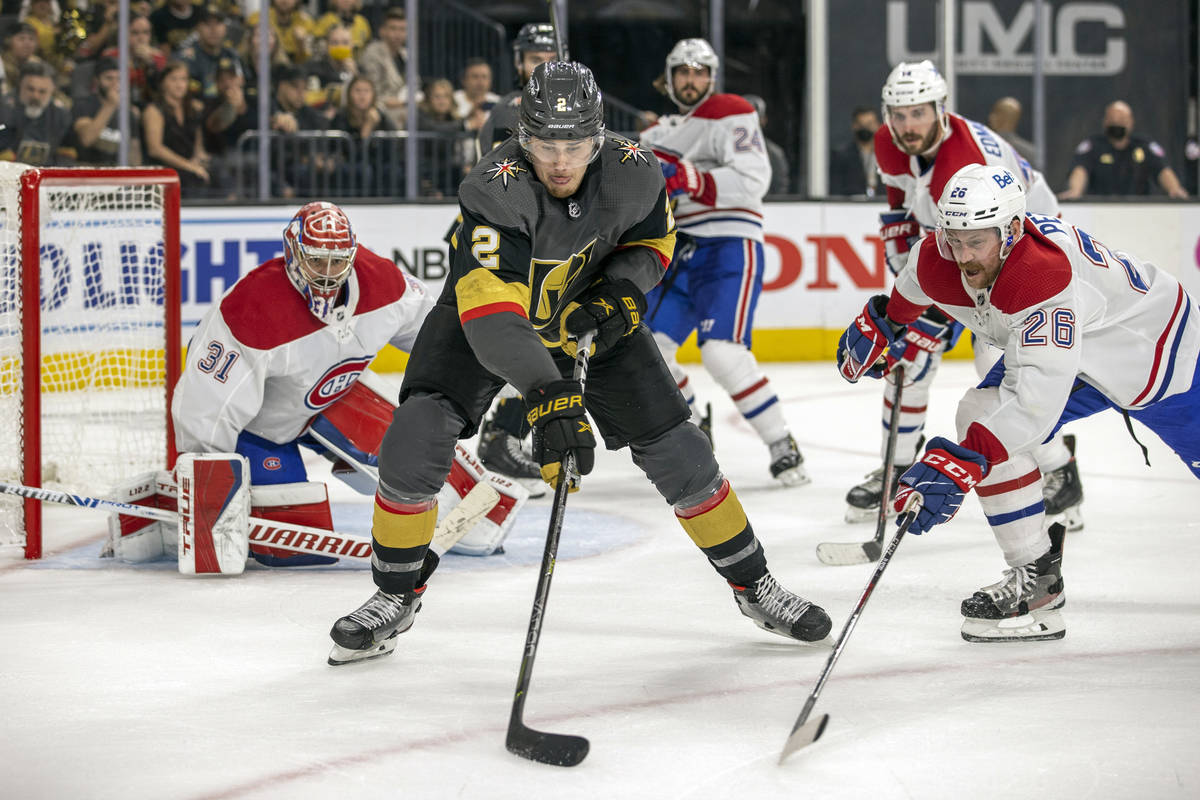 Golden Knights defenseman Zach Whitecloud (2) secures the puck over Montreal Canadiens defensem ...