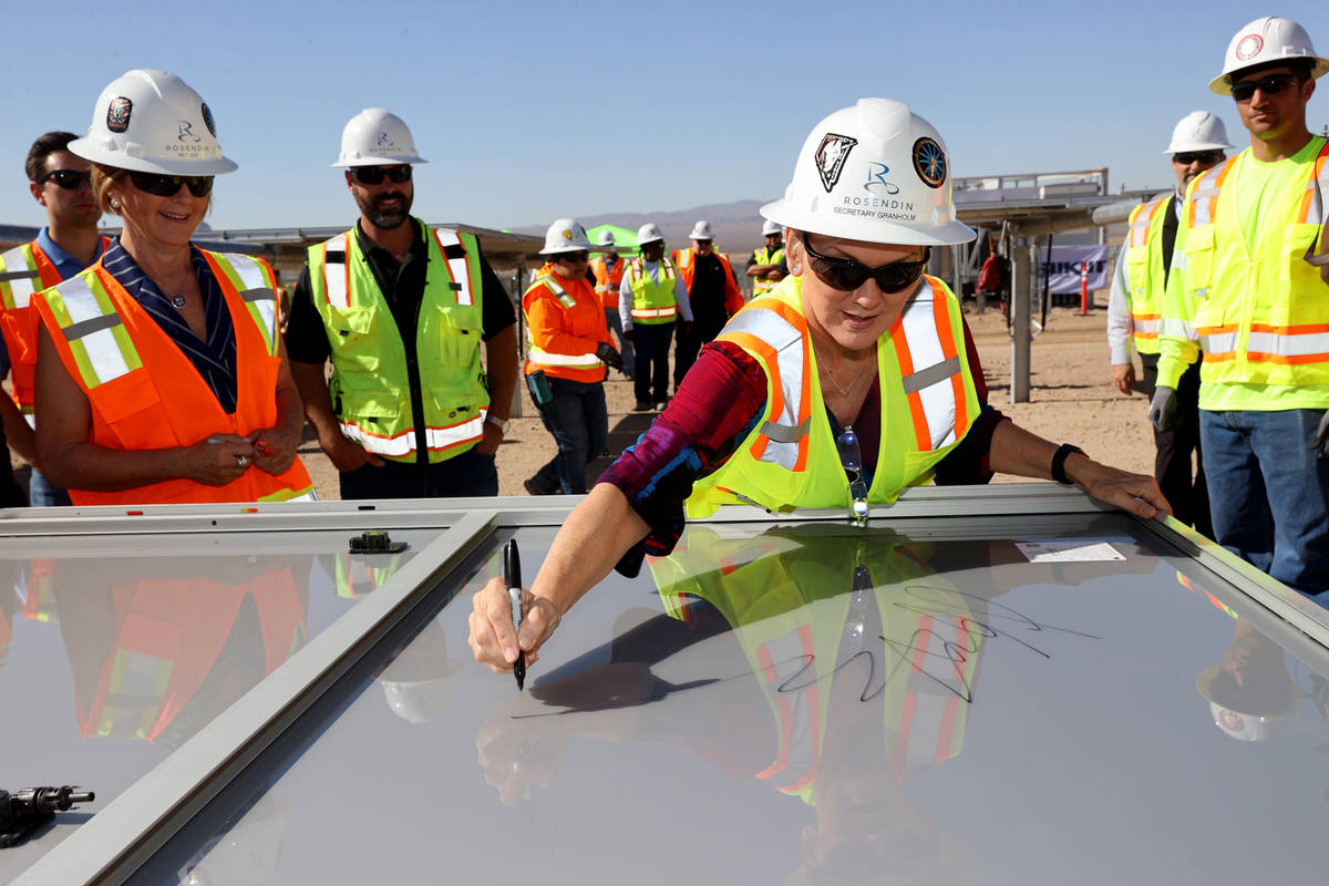 U.S. Energy Secretary Jennifer Granholm tours signs a solar module at Townsite solar facility i ...