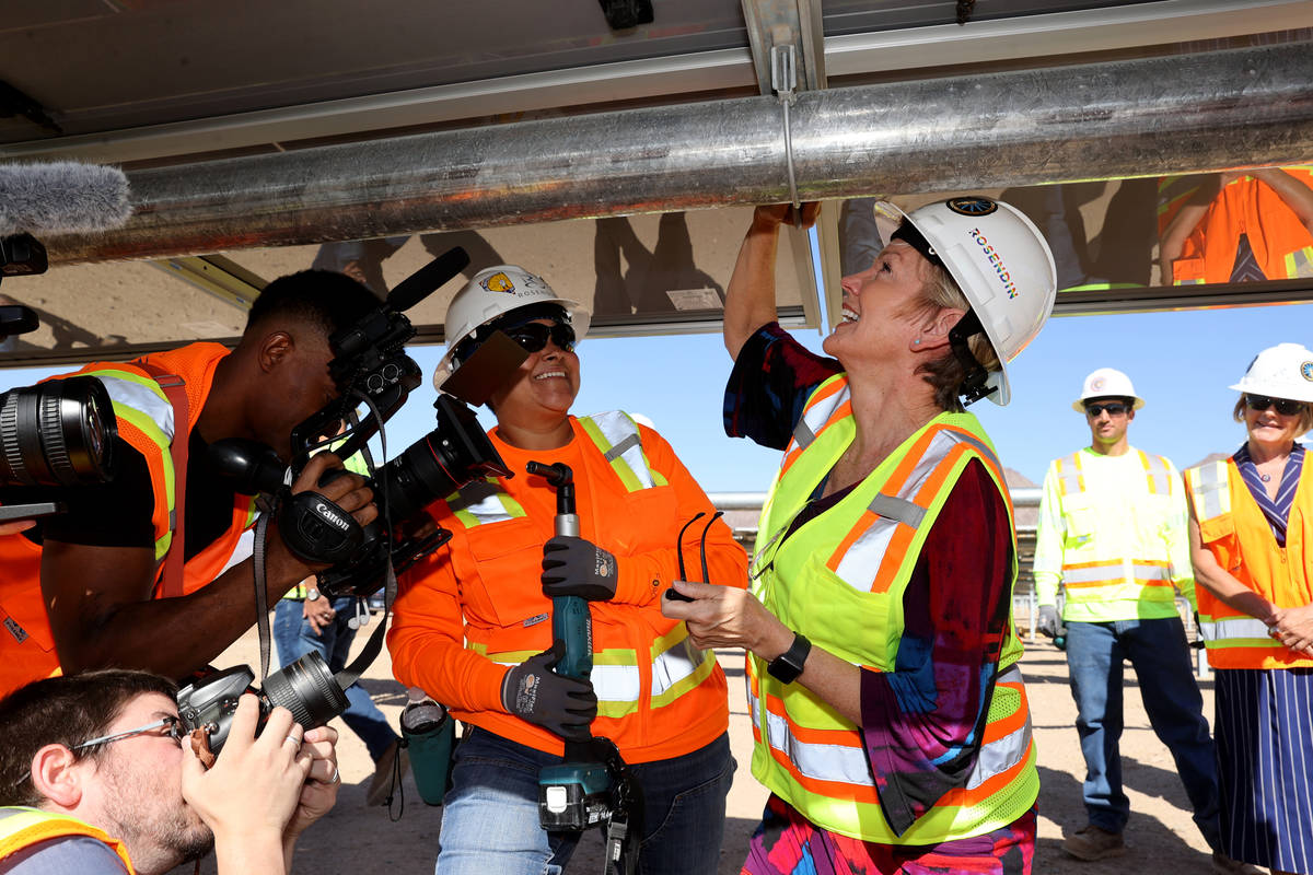 U.S. Energy Secretary Jennifer Granholm, right, signs a module after installing it with journey ...