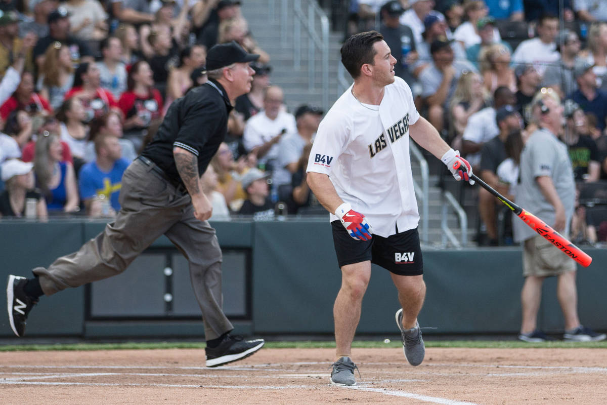 Golden Knights center Jonathan Marchessault, right, watches his ball sail over the left field w ...