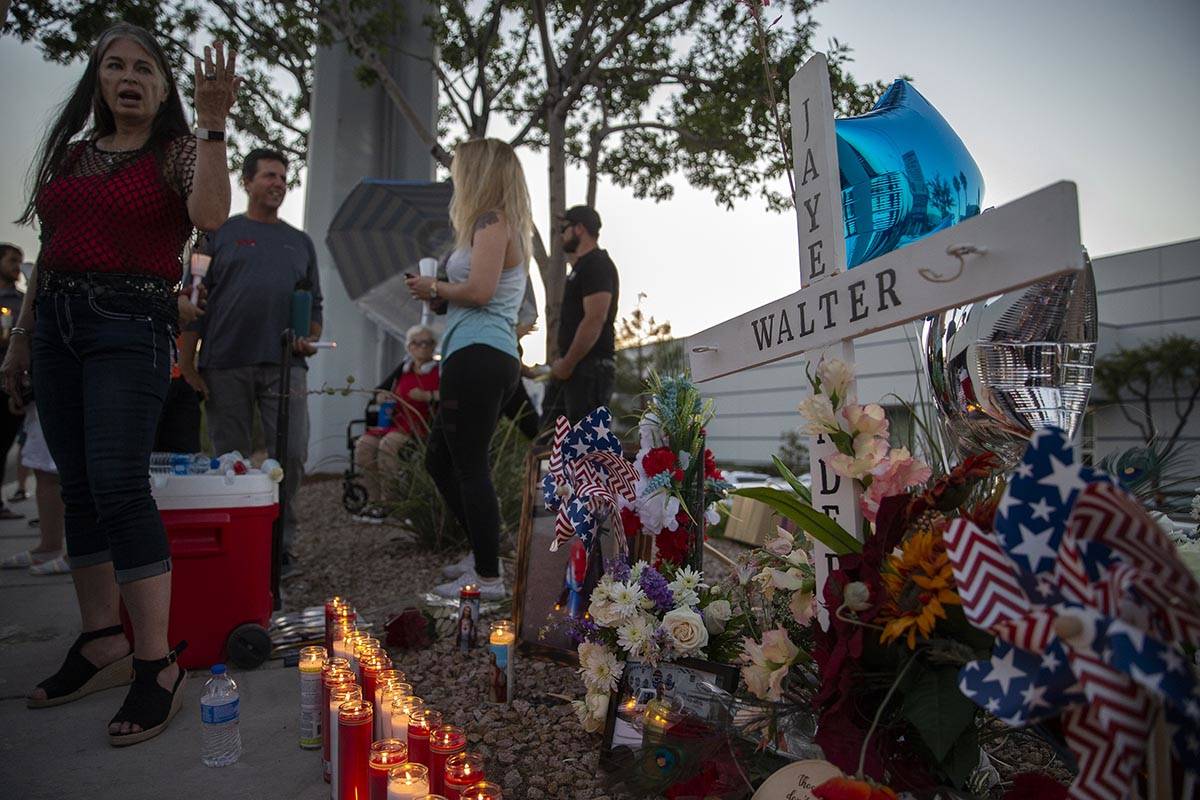 Joan Anderson, left, talks to family and friends at a vigil for her brothre Walter Anderson nea ...