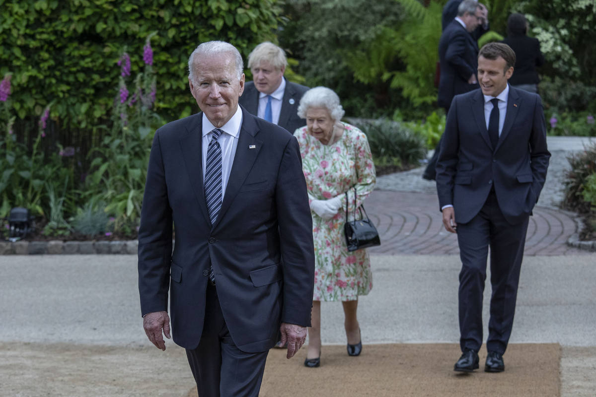 Britain's Queen Elizabeth II, centre walks with French President Emmanuel Macron, Britain's Pr ...
