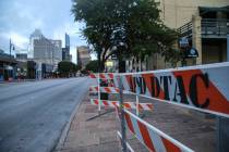 Road block barriers sit on the sidewalk on 6th Street after an early morning shooting on Saturd ...