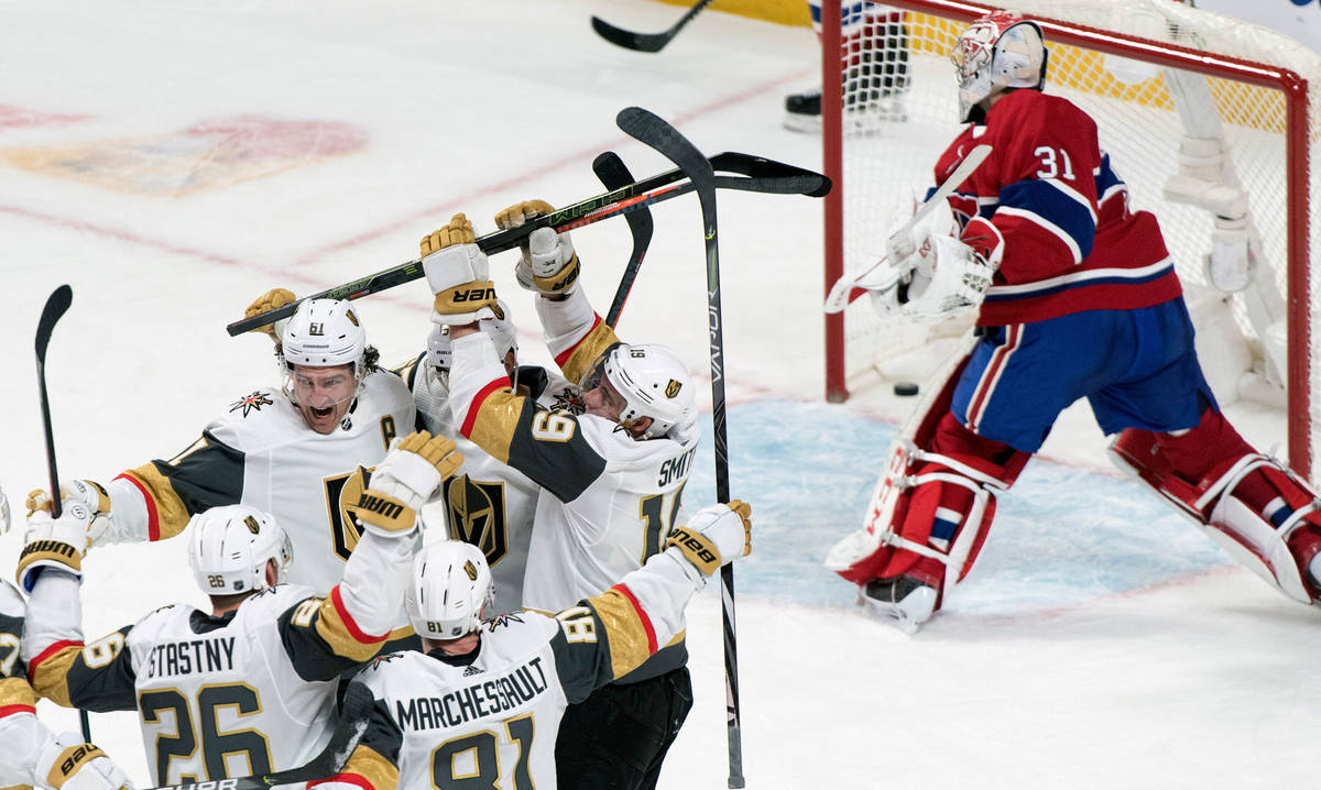 Montreal Canadiens goaltender Carey Price, right, breaks his stick after being scored against b ...