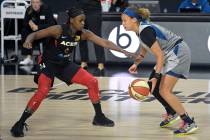 Las Vegas Aces guard Sugar Rodgers (14) defends against Minnesota Lynx guard Rachel Banham, rig ...