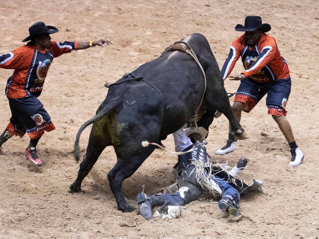 Ezekiel Mitchell, of Rockdale, Texas., is thrown while atop of Machin as he competes Bull Ridin ...