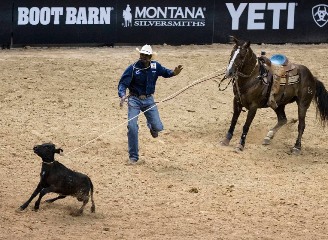 Jeremy Burkhalter, of Houston, Texas, participates in calf roping competition at the Bill Picke ...