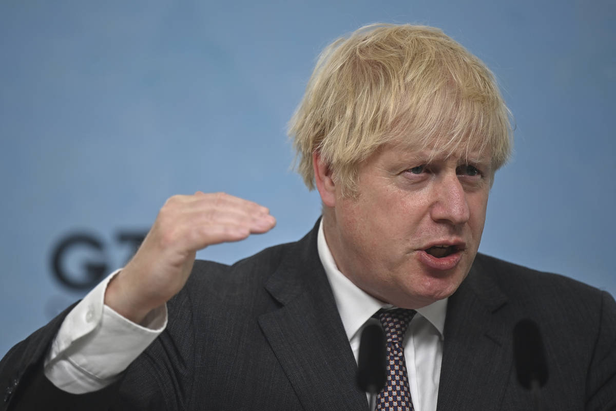 Britain's Prime Minister Boris Johnson gestures, during a press conference on the final day of ...