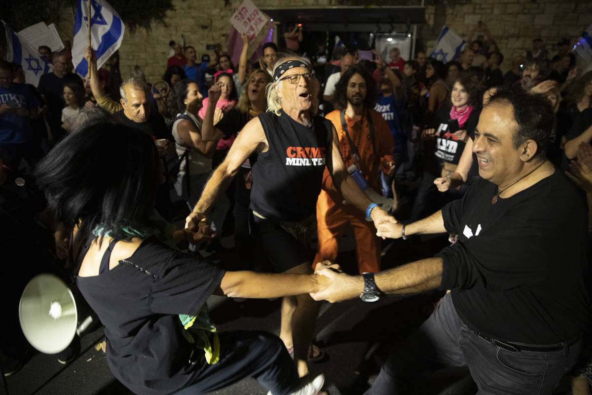 Israeli protesters dance and cheer during a demonstration against Israeli Prime Minister Benjam ...