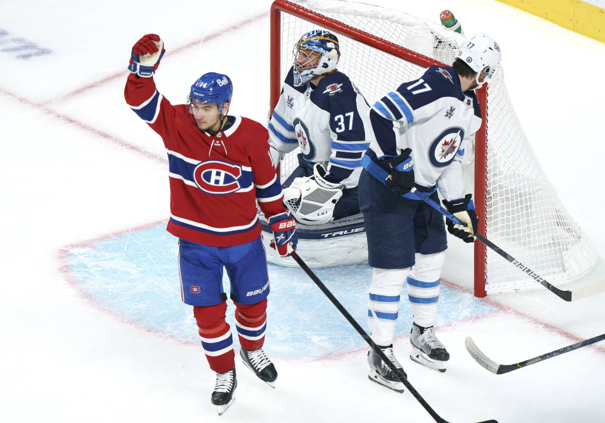 Montreal Canadiens' Nick Suzuki celebrates his goal past Winnipeg Jets goaltender Connor Helleb ...