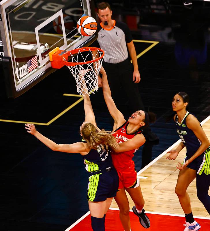 Las Vegas Aces' Dearica Hamby (5) goes to the basket against Dallas Wings' Bella Alarie (32) du ...