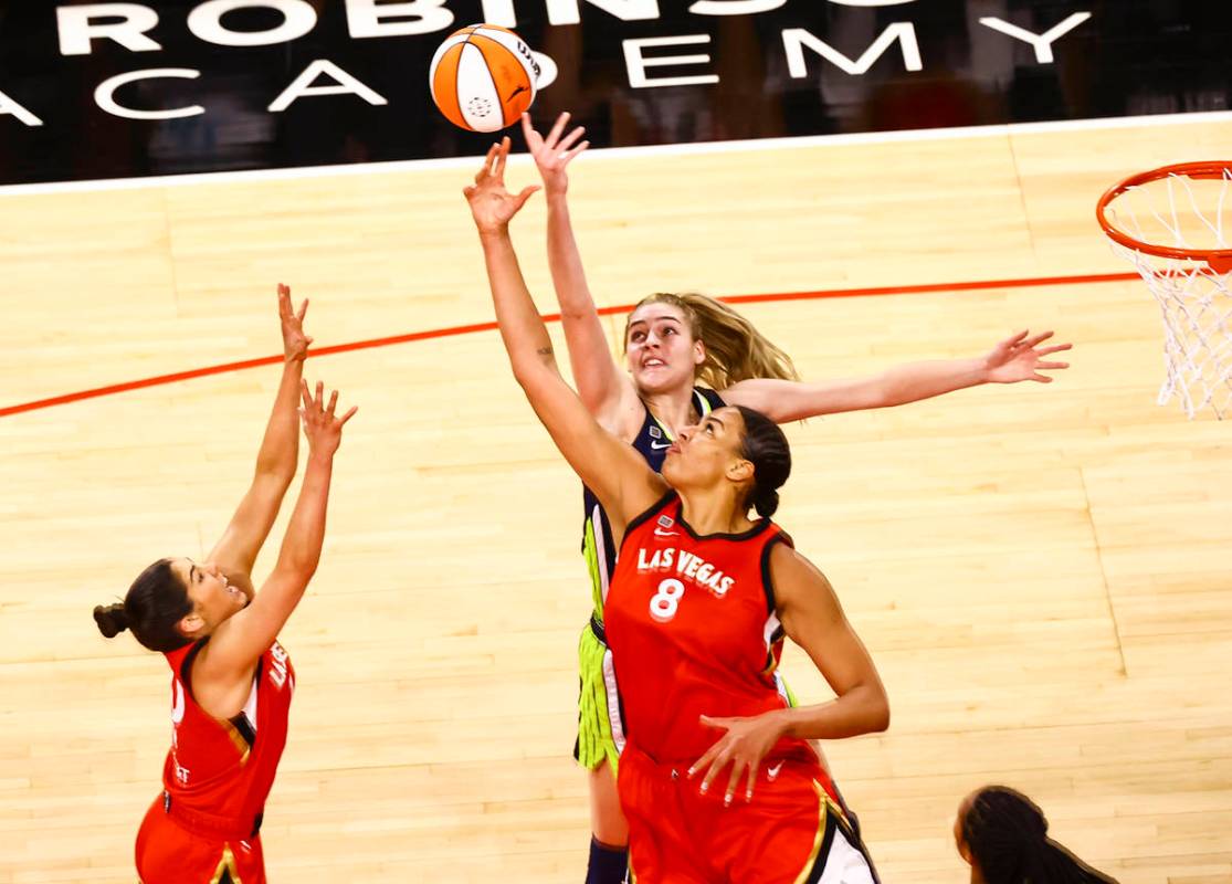 Dallas Wings' Bella Alarie, above, and Las Vegas Aces' Liz Cambage (8) battle for a rebound dur ...
