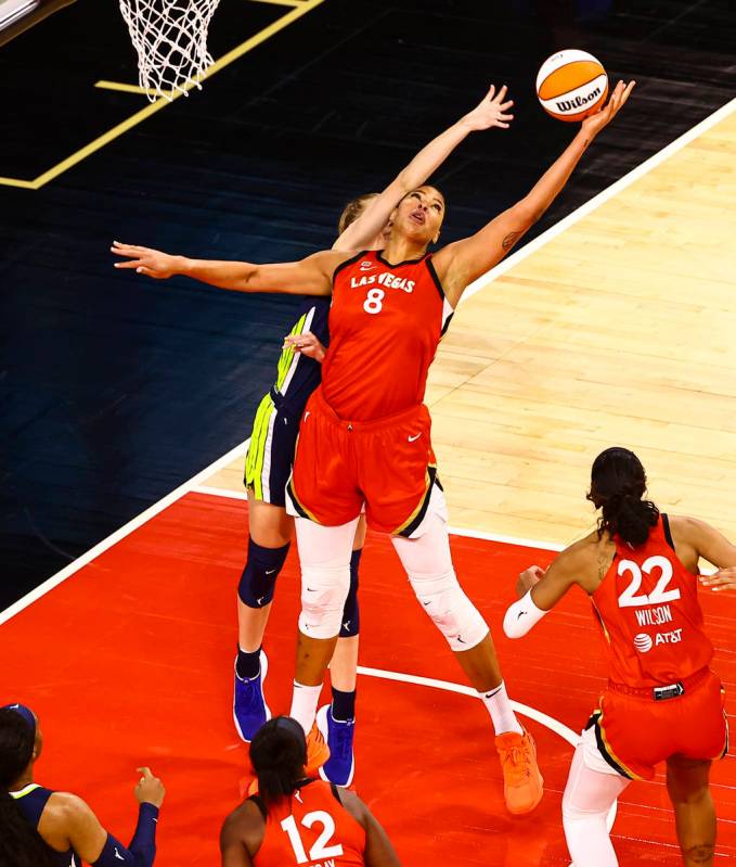 Las Vegas Aces' Liz Cambage (8) grabs a rebound against Dallas Wings' Bella Alarie (32) during ...