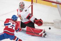 In this May 1, 2021, file photo, Montreal Canadiens' Cole Caufield scores against Ottawa Senato ...