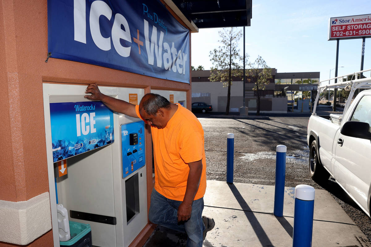 Ramiro Torres gets ice for his work day at a kiosk on the corner of Smoke Ranch Road and Jones ...