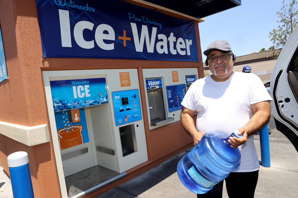 Pedro Soto gets water at a kiosk on the corner of Smoke Ranch Road and Jones Boulevard Monday, ...