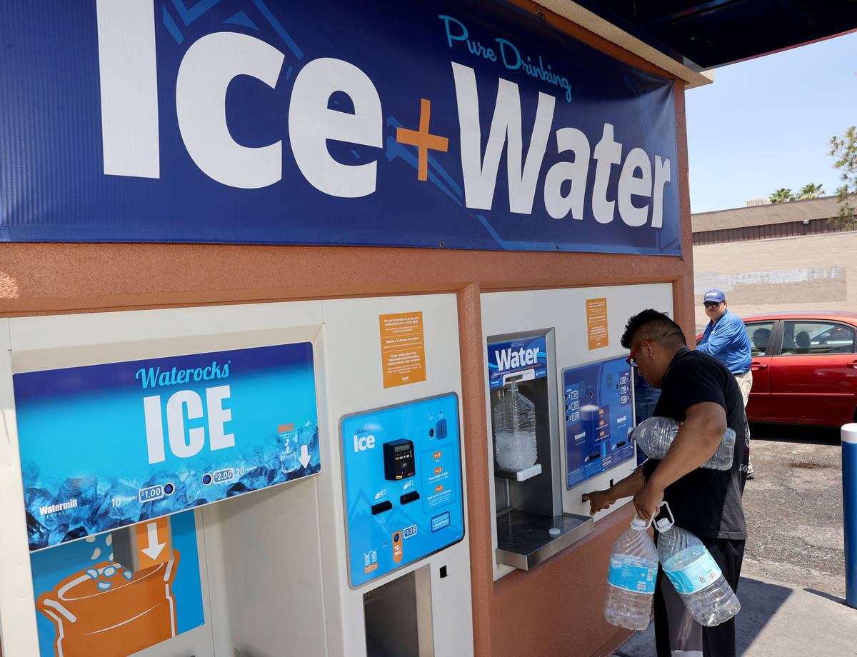 Jaime Juarez, 39, gets water at a kiosk on the corner of Smoke Ranch Road and Jones Boulevard M ...