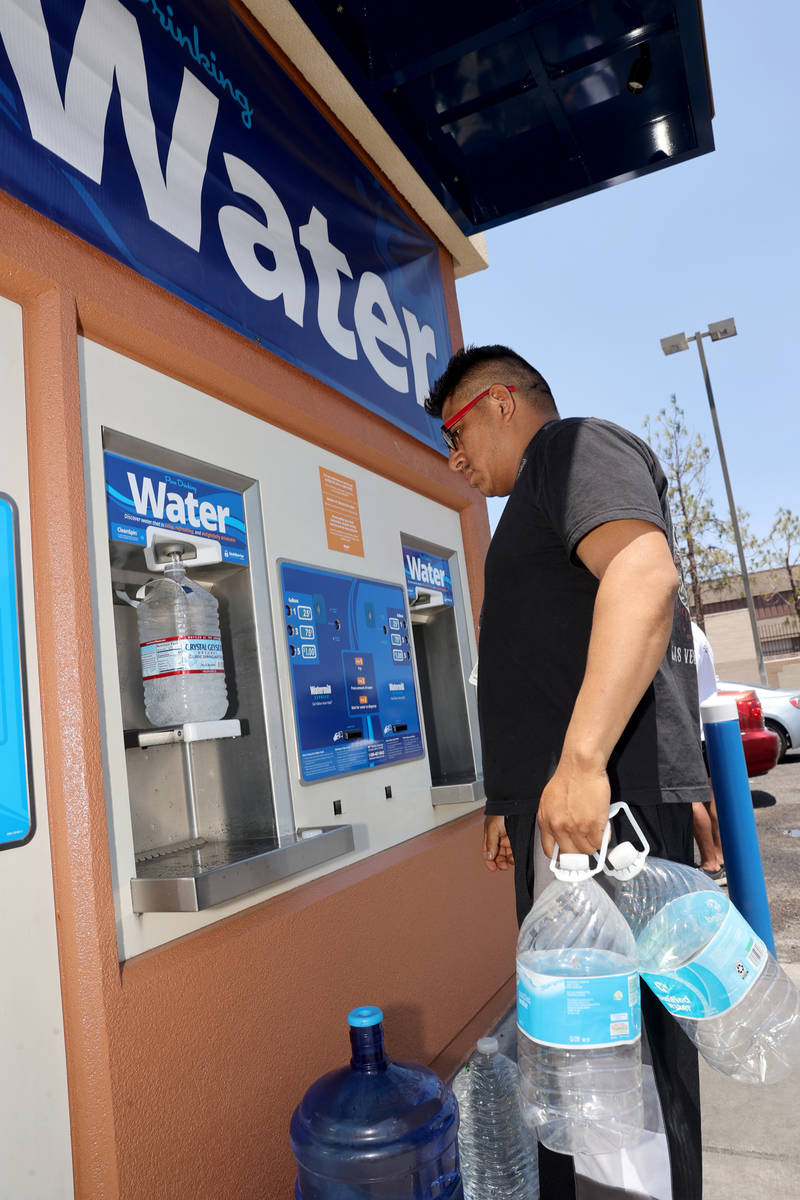 Jamie Juarez, 39, gets water at a kiosk on the corner of Smoke Ranch Road and Jones Boulevard M ...