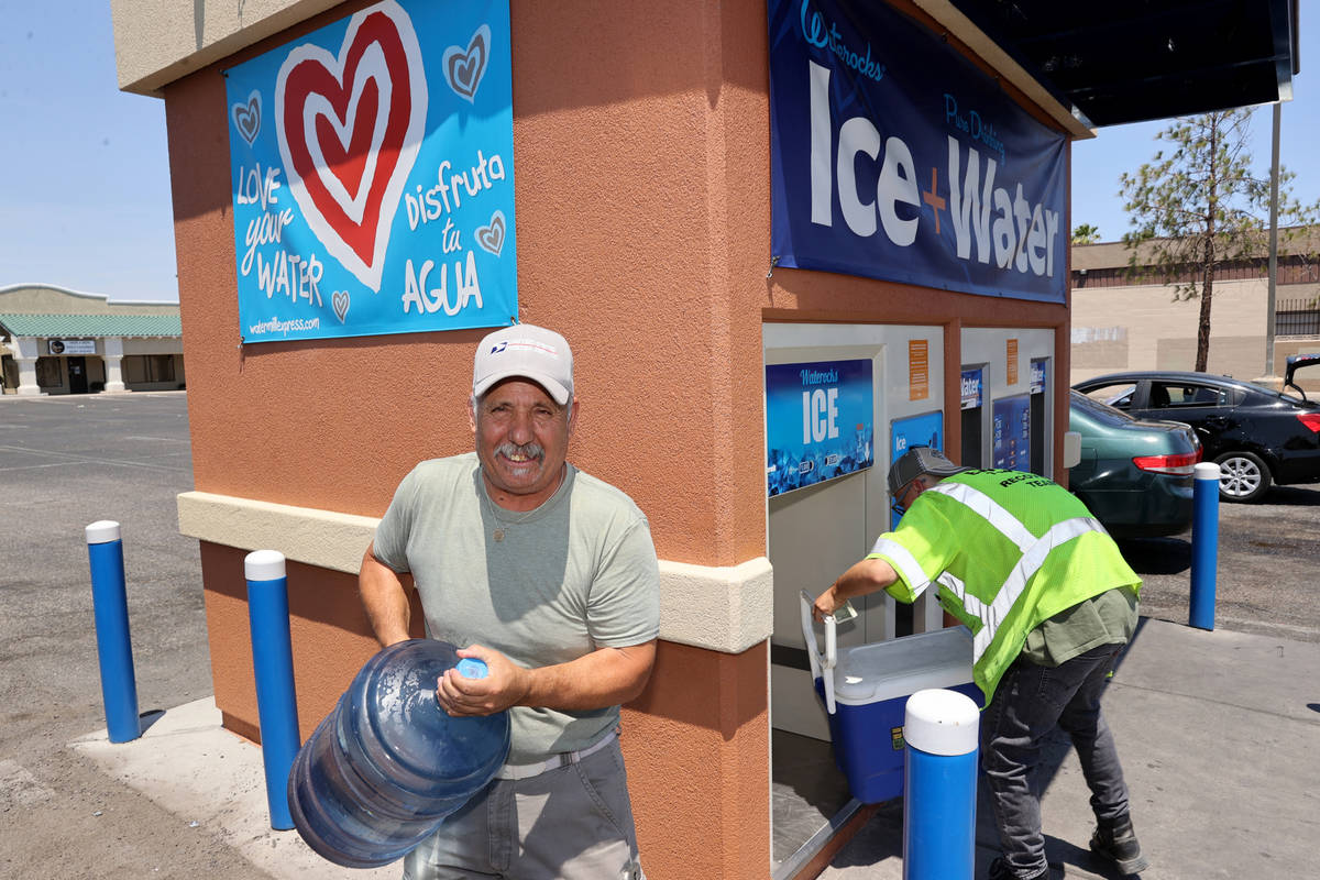 Ron Alvarez gets water at a kiosk on the corner of Smoke Ranch Road and Jones Boulevard Monday, ...