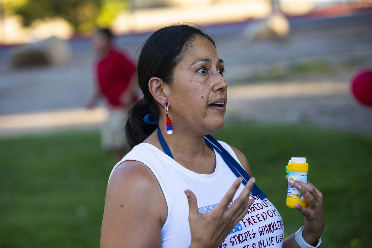 Dina Lynn of Las Vegas speaks during a vigil in memory of Liam Husted, who was found slain near ...