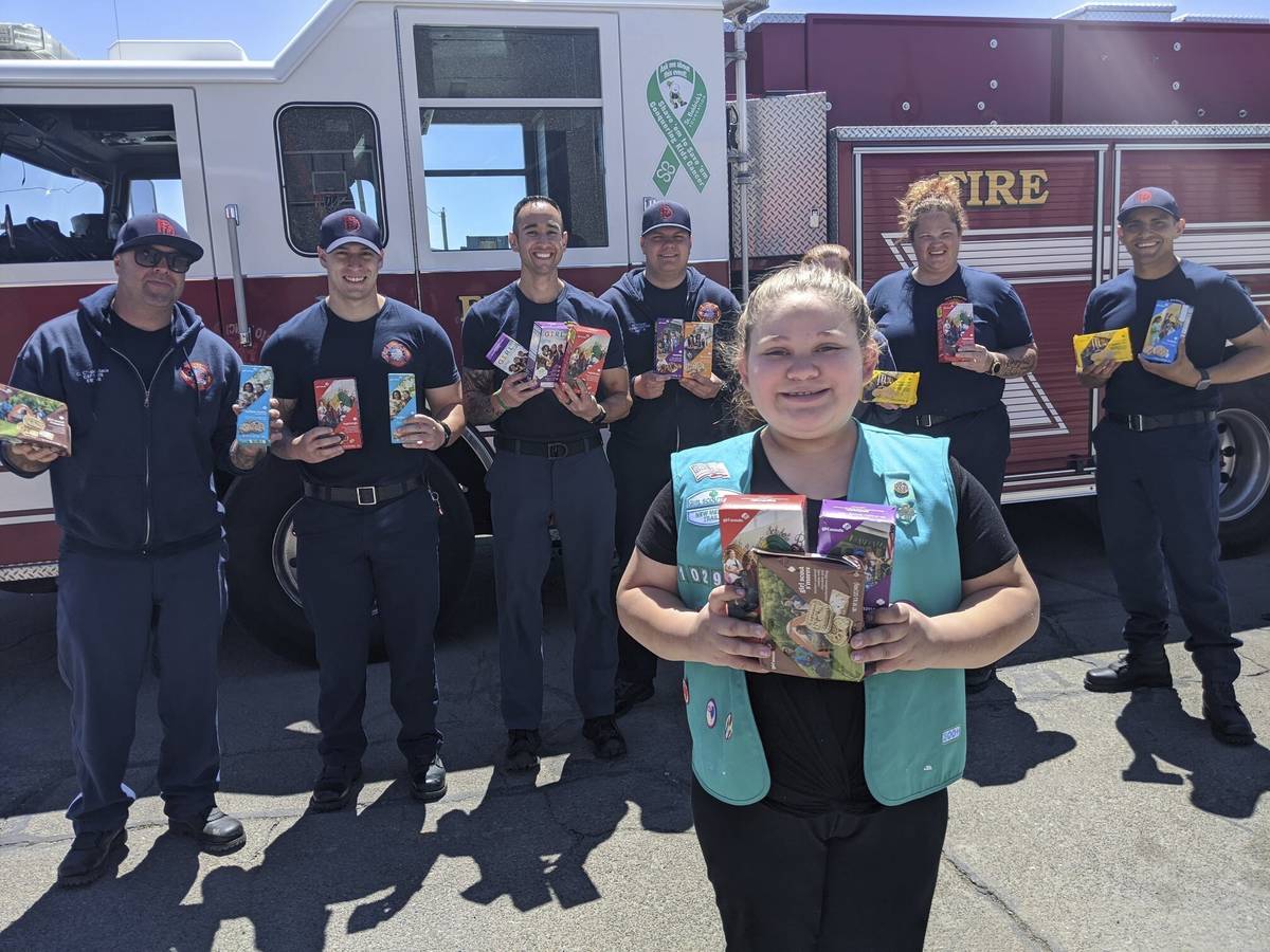 This undated photo provided by Girl Scouts of New Mexico Trails shows a scout donating cookies ...