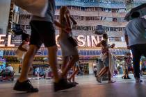 Visitors wander along the shops and casinos at the Fremont Street Experience on Monday, June 14 ...