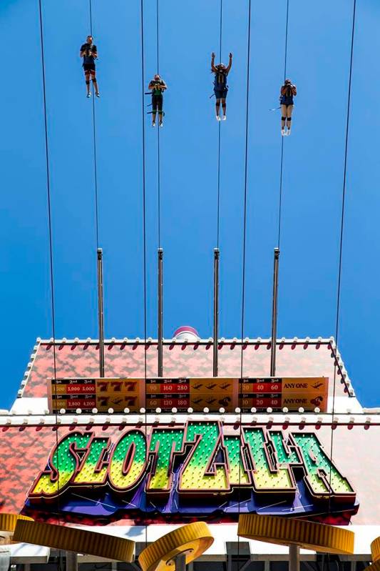 Slotzilla riders leave the platform for a run down the zipline at the Fremont Street Experience ...