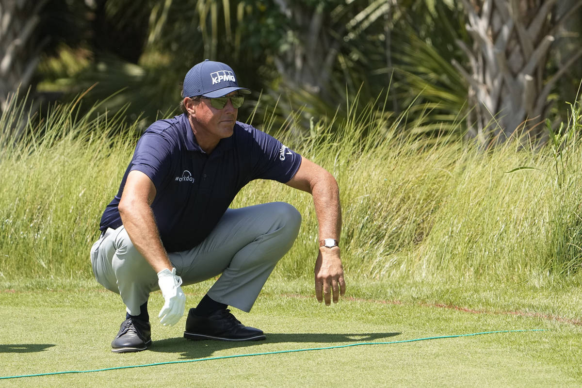 Phil Mickelson stretches before hitting off the second tee during the final round at the PGA Ch ...