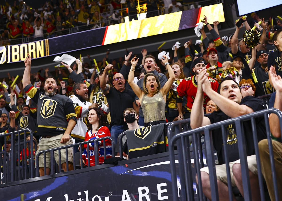 Golden Knights fans celebrate after a goal by defenseman Shea Theodore, not pictured, during th ...