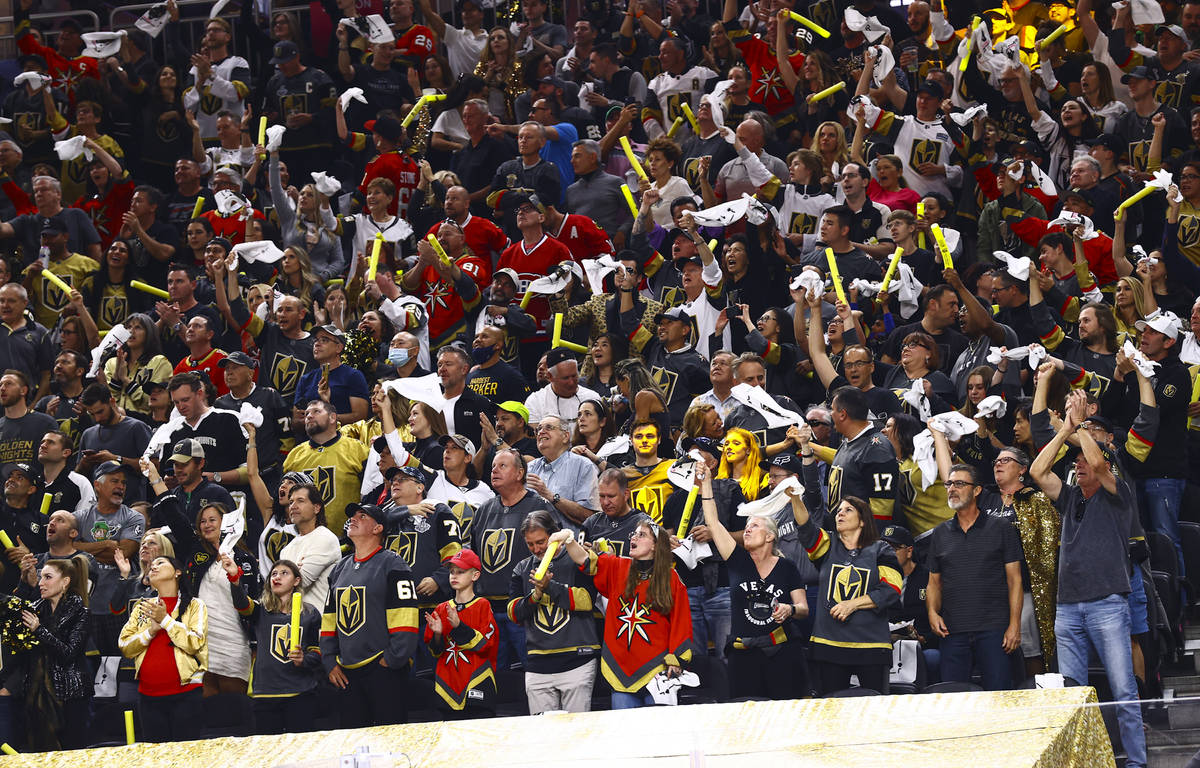 Golden Knights fans celebrate after a goal by defenseman Shea Theodore, not pictured, during th ...