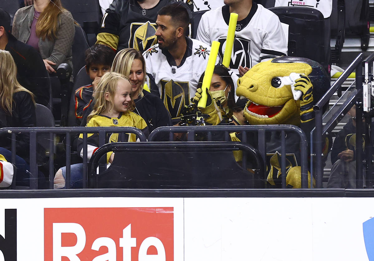 Golden Knights mascot Chance, right, hangs out with a young fan during the first period of Game ...