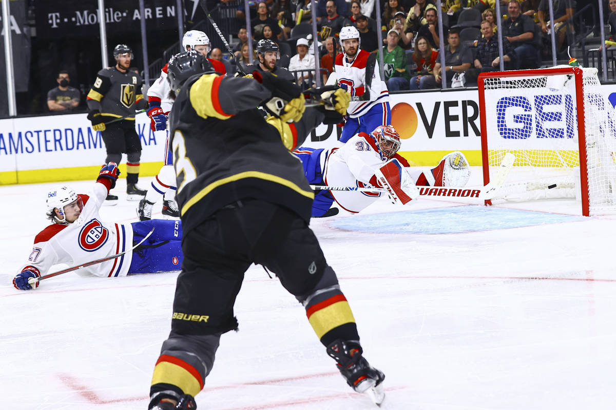 Golden Knights’ Alec Martinez (23) scores a goal past Montreal Canadiens goaltender Care ...
