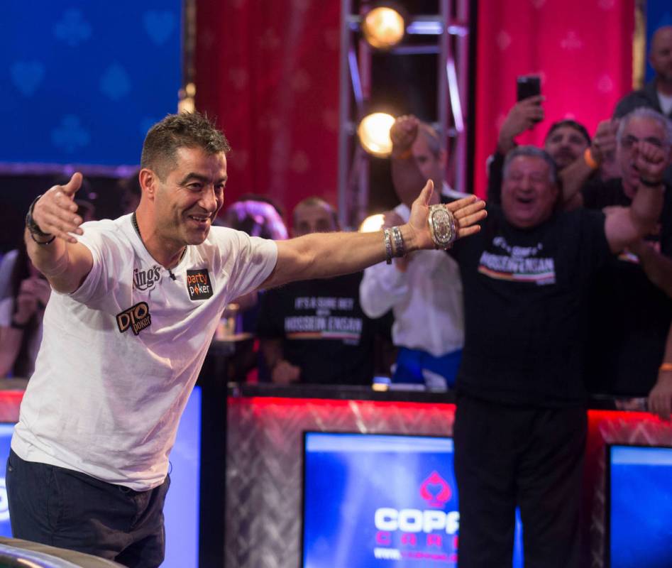 Hossein Ensan, left, from Germany, bows to his fans after winning the World Series of Poker Mai ...