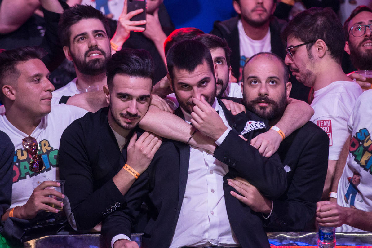 Dario Sammartino, middle, from Italy, celebrates with fans after advancing to the final two pla ...