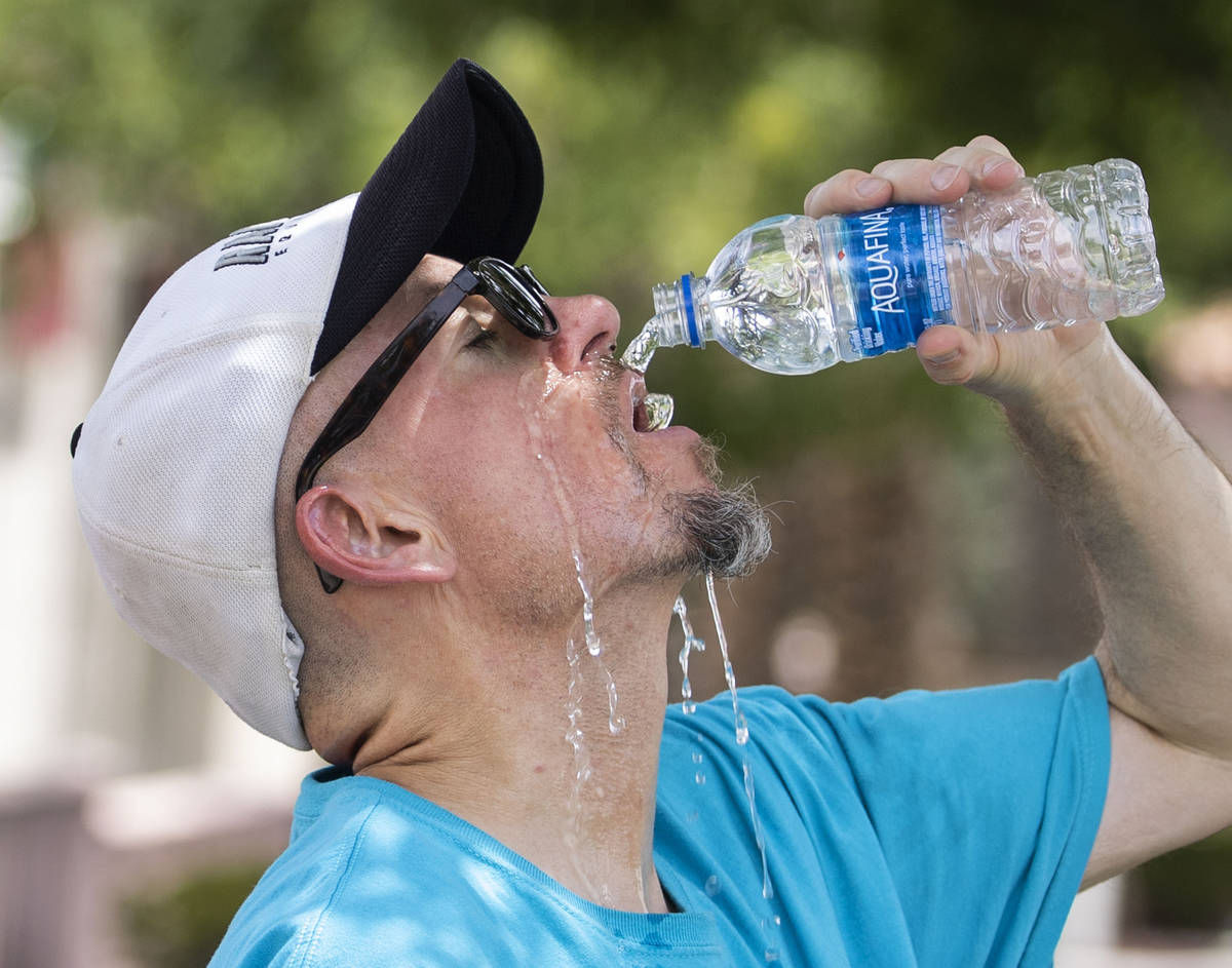 Jerry V., who declined to give his last name, cools himself off as he takes a break from runnin ...