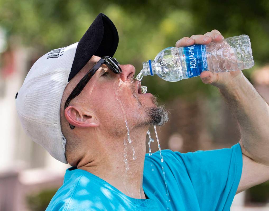 Jerry V., who declined to give his last name, cools himself off as he takes a break from runnin ...