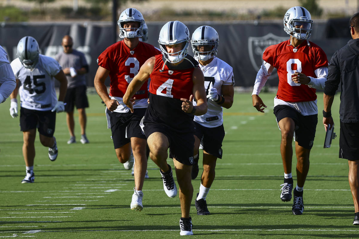 Raiders quarterback Derek Carr (4) warms up with teammates during an NFL football minicamp at R ...