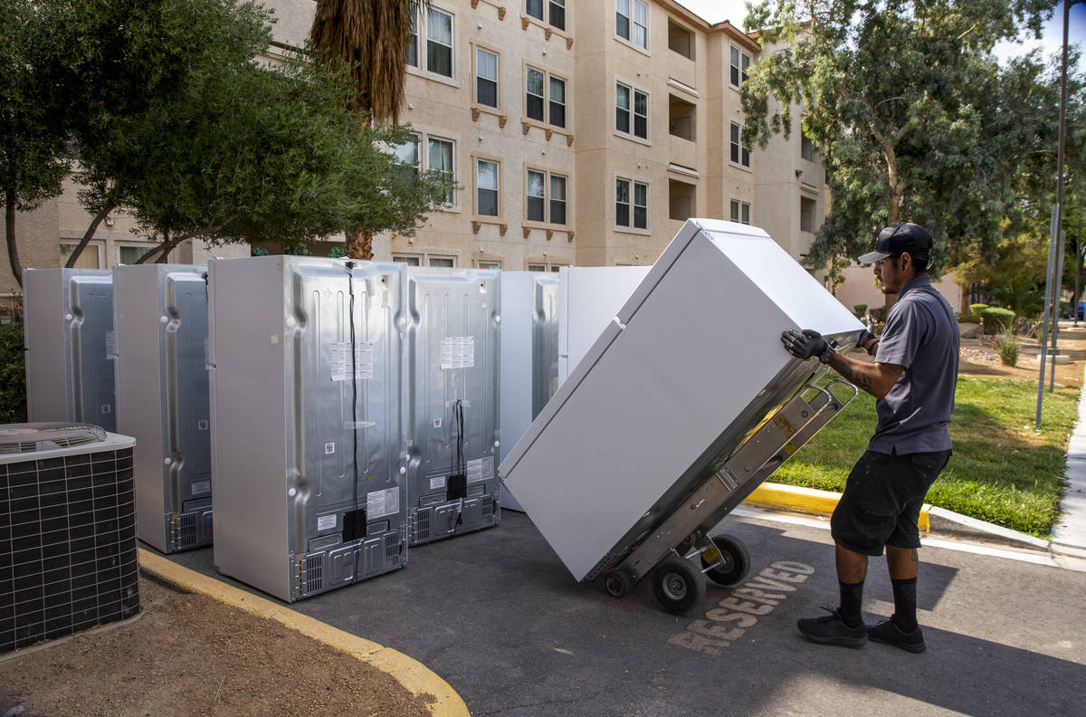 Lowe's employee Romanldo Lazaro moves one of the 98 fridges at Bonanza Pines Senior Living bein ...