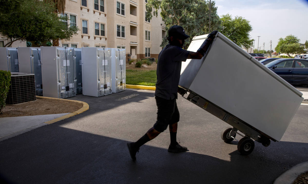 Lowe's employee Romanldo Lazaro moves one of the 98 fridges at Bonanza Pines Senior Living bein ...