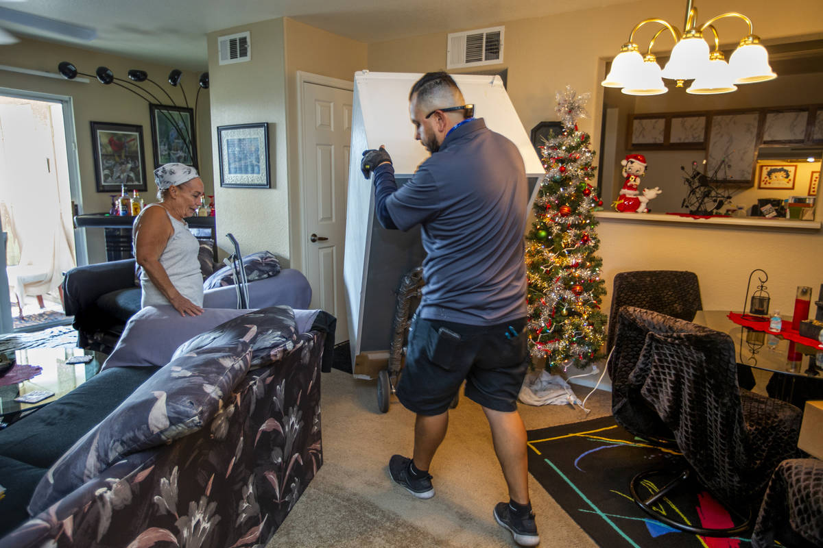 Resident Carol Sloncik, left, looks on as Lowe's employee Albert Vazquez delivers one of the 98 ...