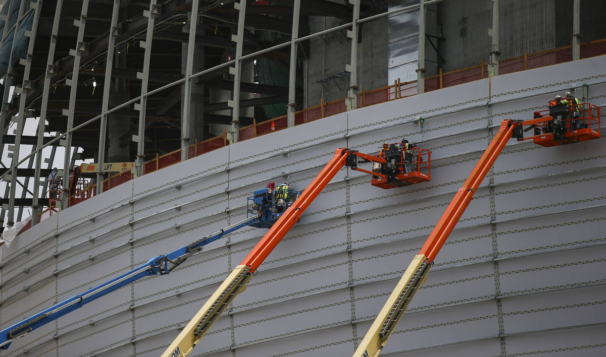 Construction workers on lifts make progress during a tour of the Madison Square Garden Sphere a ...