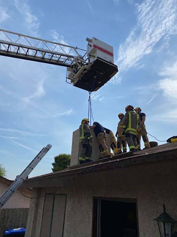 Henderson firefighters rescue an 18-year-old woman from the chimney of a home near Horizon Driv ...