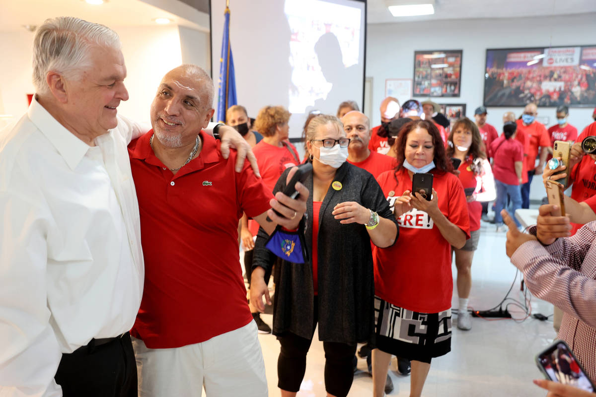 Culinary Workers Union Local 226 member Jorge Padilla, second from right, greets Gov. Steve Sis ...