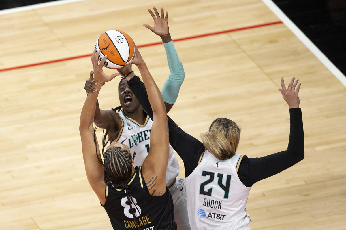Las Vegas Aces center Liz Cambage (8) is blocked by New York Liberty guard Jazmine Jones (4) an ...