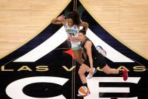 Las Vegas Aces guard Kelsey Plum (10) dribbles around New York Liberty guard/forward Betnijah L ...