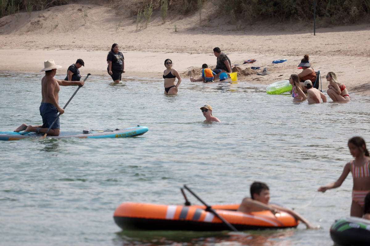 People cool down from the heat in the Colorado River at the Colorado River Heritage Greenway Pa ...