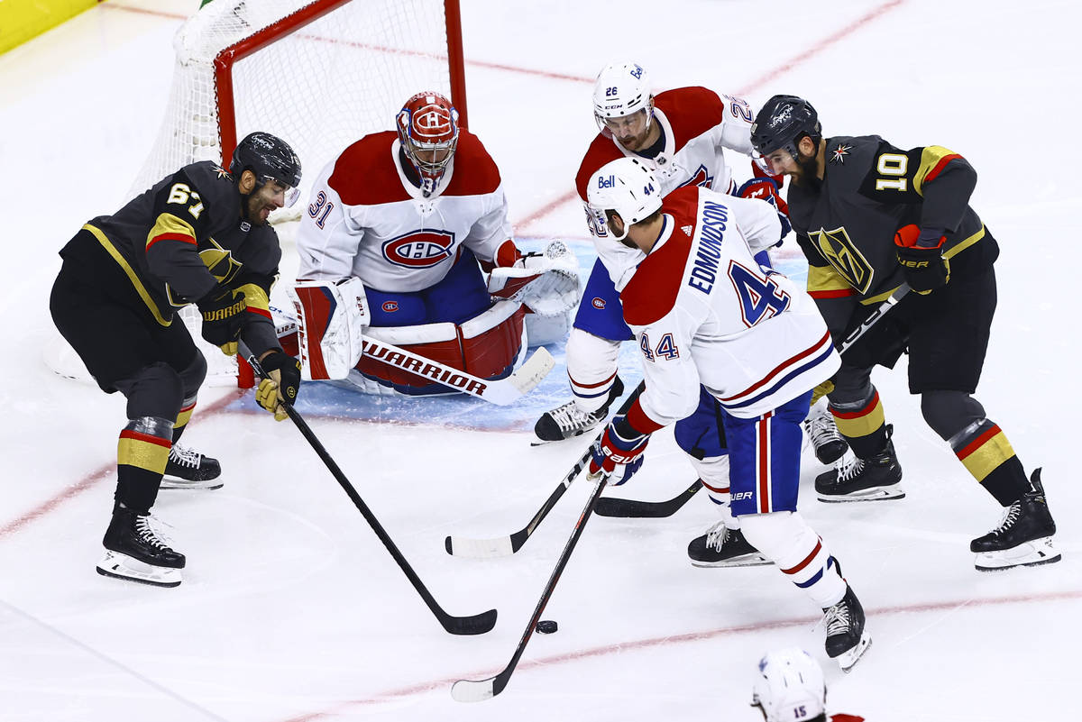Golden Knights' Max Pacioretty (67) and Nicolas Roy (10) vie for the puck against Montreal Cana ...