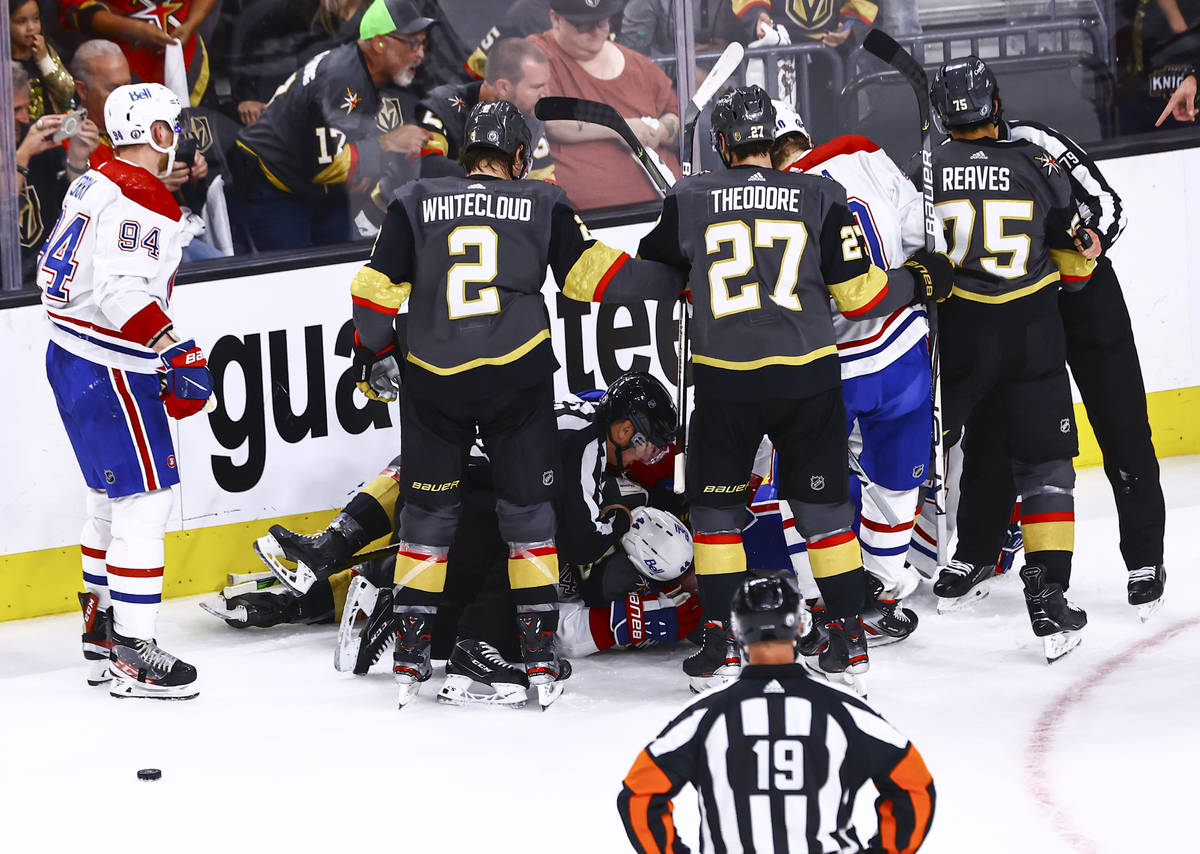 A referee tries to break up a fight between the Golden Knights and Montreal Canadiens during th ...