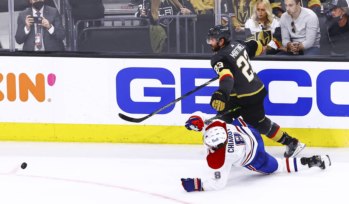Golden Knights' Alec Martinez (23) and Montreal Canadiens' Ben Chiarot (8) vie for the puck dur ...