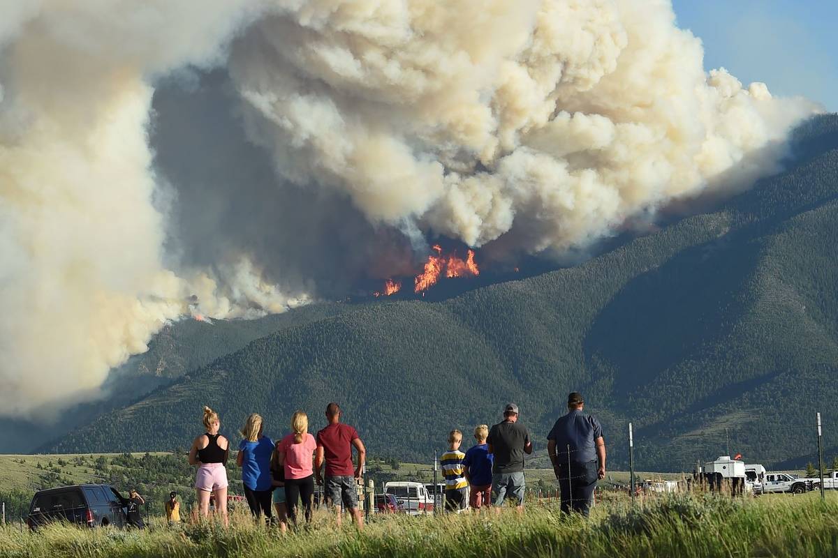 Residents watch as flames from the Robertson Draw fire burn above Red Lodge, Mont., Tuesday eve ...